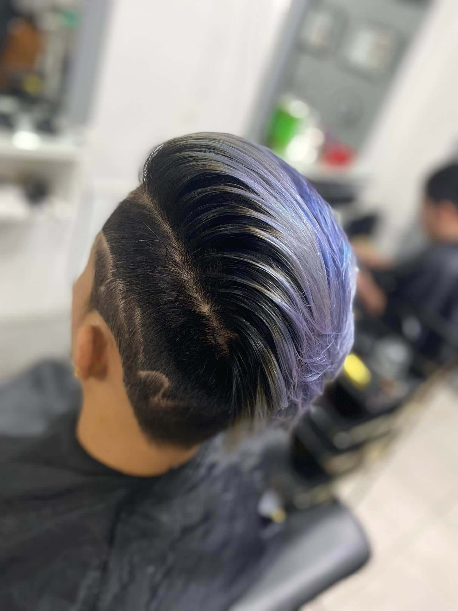 Modern men's haircut with skin fade finished at Charlie's Barbershop